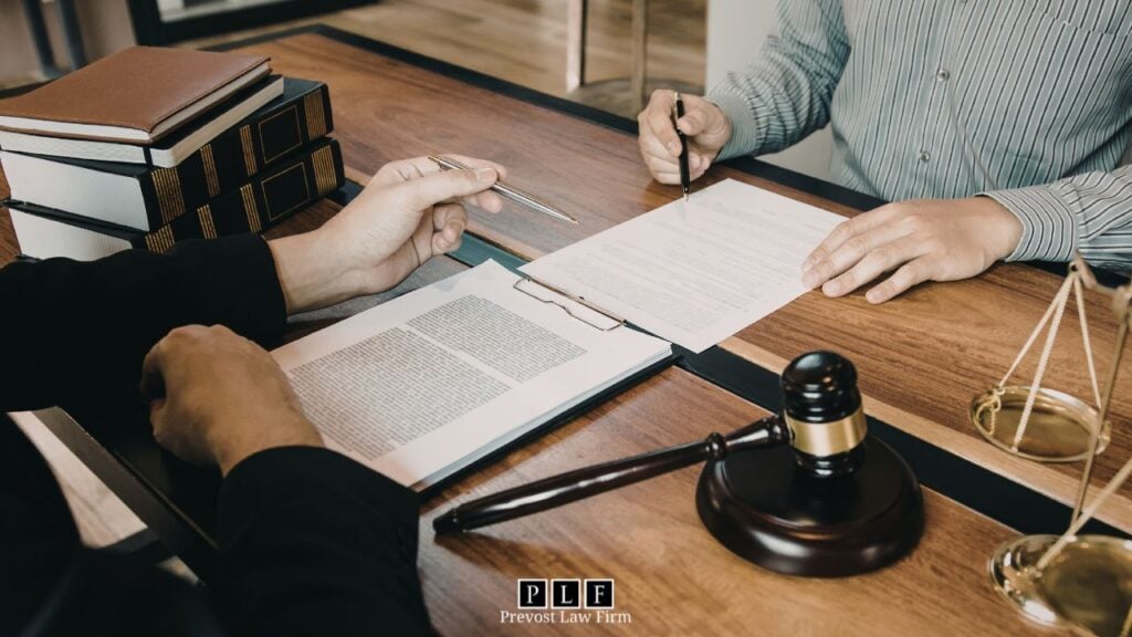A person signing documents with a wage garnishment lawyer.